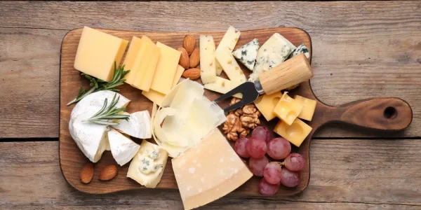 Cheese,Plate,With,Grapes,And,Nuts,On,Wooden,Table,,Top