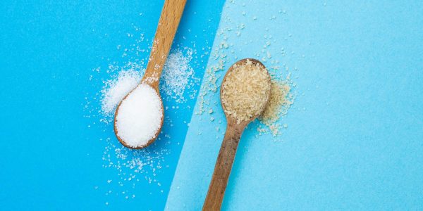 White,Versus,Brown,Sugar,Crystals,On,Wooden,Tea,Spoons,,And