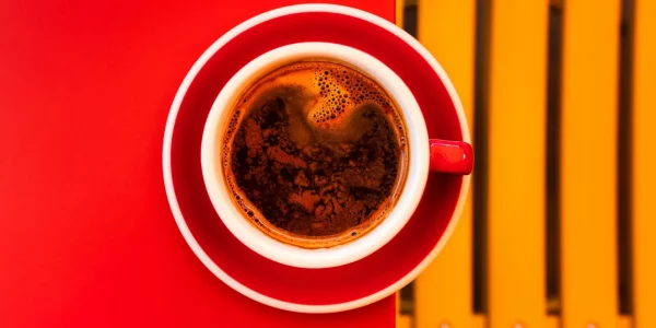 A,Red,Cup,Of,Black,Coffee,On,A,Saucer,On