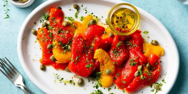 Bell,Pepper,Salad,With,Capers,And,Olive,Oil.,Blue,Background.