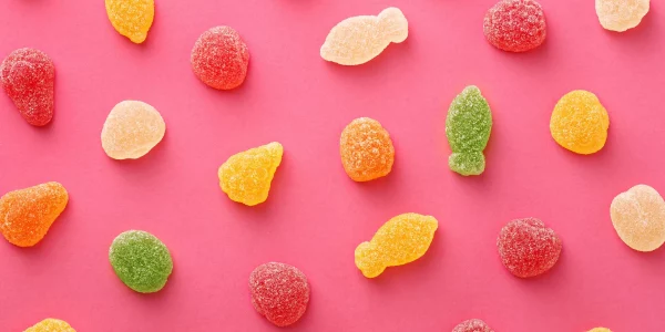 Colorful,Gummy,Candies,Pattern,On,A,Pink,Background.,Soft,Gums