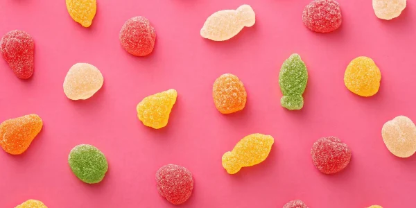 Colorful,Gummy,Candies,Pattern,On,A,Pink,Background.,Soft,Gums